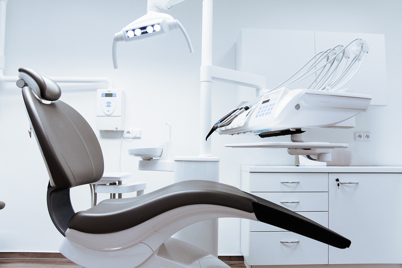 Modern dental operatory with dental chair, overhead exam light, and equipment in a clean, professional dental office